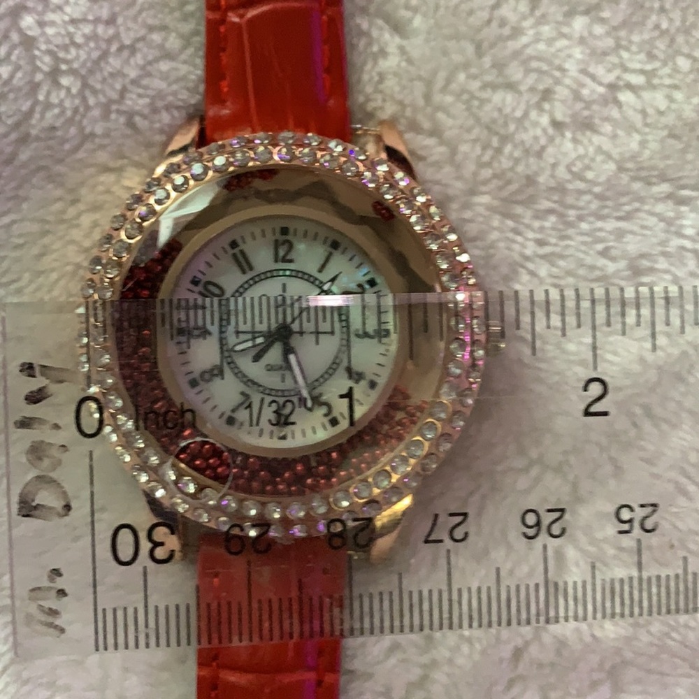 Ladies quartz wrist watch with red  leather band.